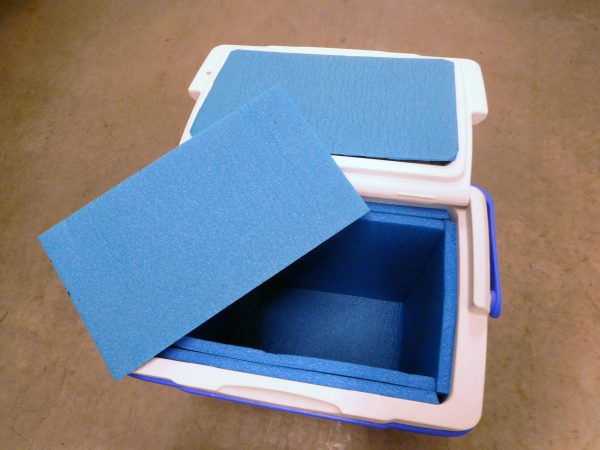 Pieces of blue foam insulation were added to a small cooler to make ice last longer.