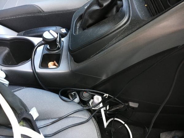 The 12-volt cord management area by the front passenger seat.