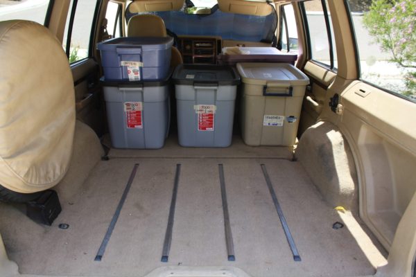 Filling the belly of the beast: start by loading the tubs toward the front of the cargo area. Water containers go in next.