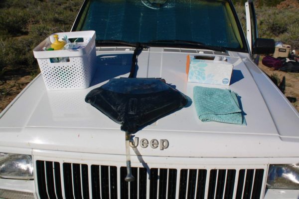 April showers: the hood is a good place to put the solar shower when washing hands and dishes. A strap attached to the windshield wiper will prevent the shower from sliding off. When you’re ready to bathe, put the shower on the roof for greater elevation.