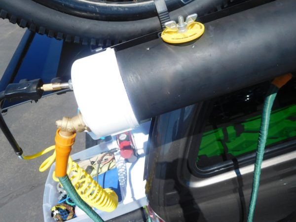 The yellow thing with the wingnut is the fill valve. A stack of a few rubber washers is between the yellow plastic part and the top of the PVC pipe. The rubber washers create an airtight seal.