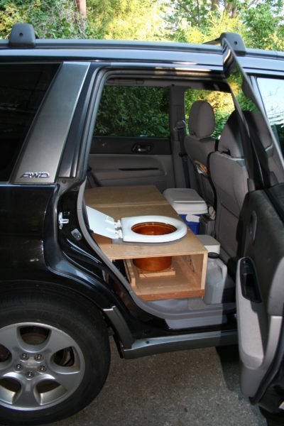 A toilet installed in a Subaru Forester.